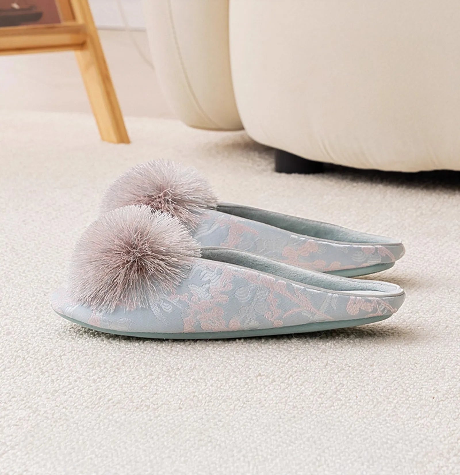 Side profile of blue floral slippers showing flat sole and fluffy detail - RoomDen