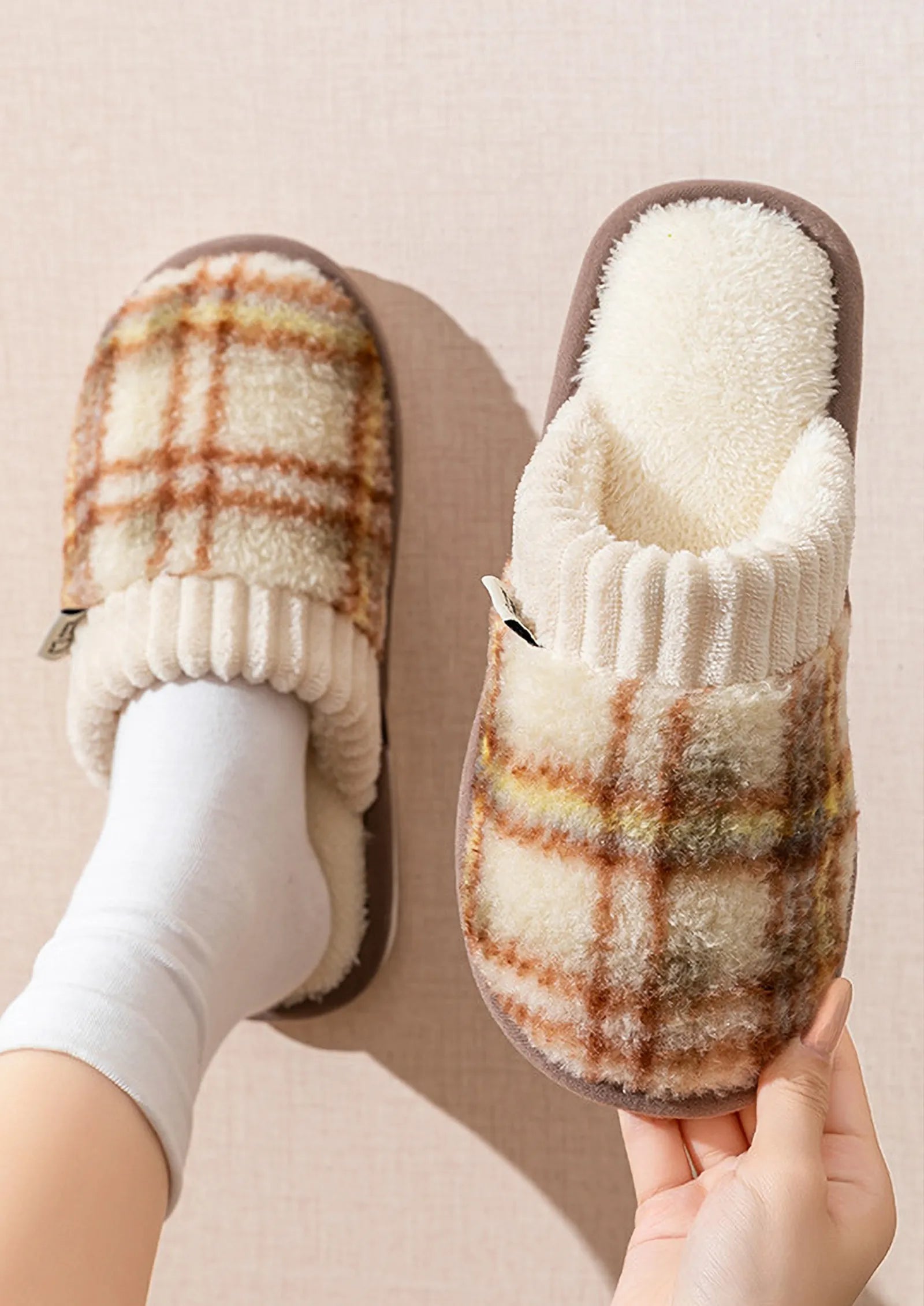 Model wearing brown and cream plaid fuzzy house slippers with white socks - RoomDen