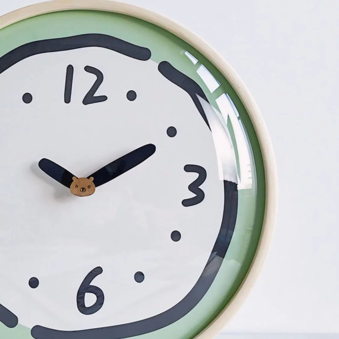 Detail shot of the cute bear on the hands of the Green Doodle Wall Clock.