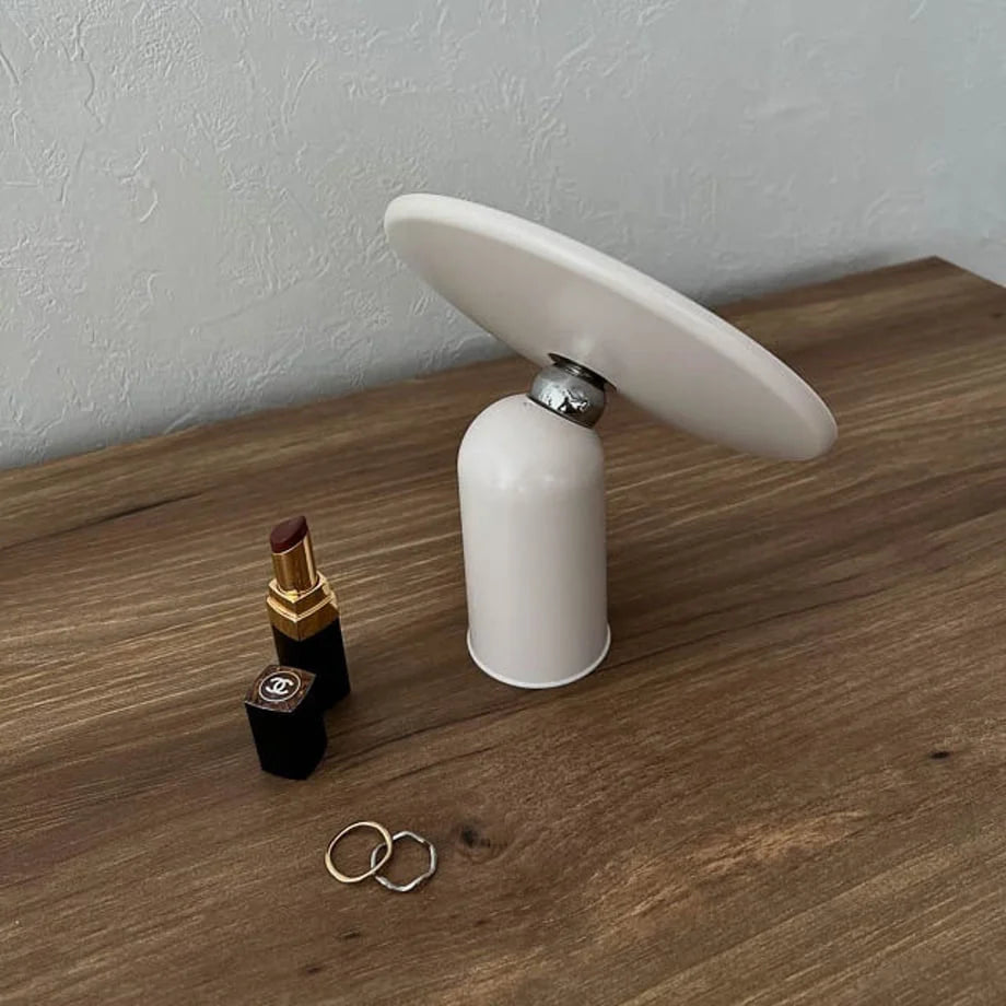 Angled view of the white minimalist vanity mirror tilted upwards.