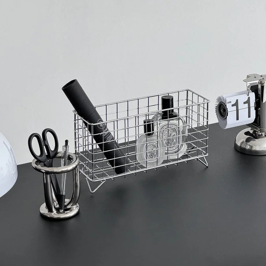 Wireframe Grid Metal Desktop Organizer holding perfume and stationery on a black desk. - RoomDen
