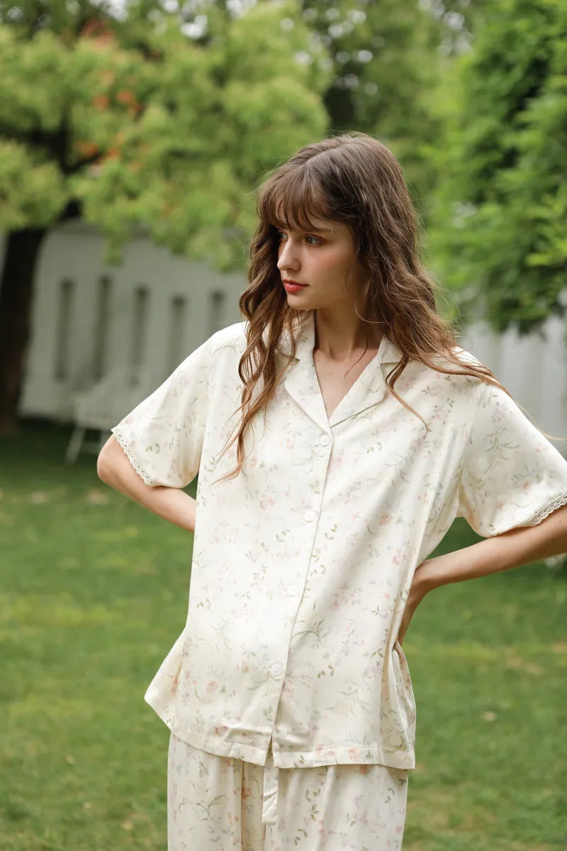 Model Wearing Vintage Style Floral Pajamas in Garden Setting - RoomDen