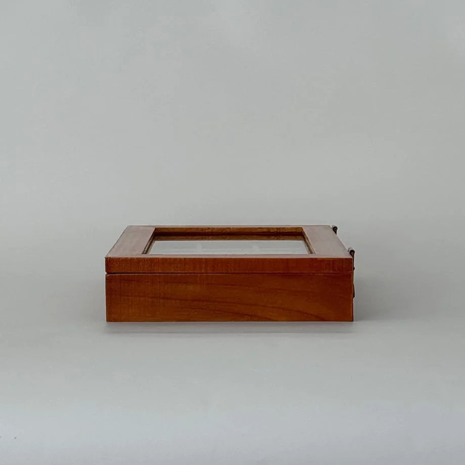 A side view of the closed wood jewelry organizer against a plain white background.