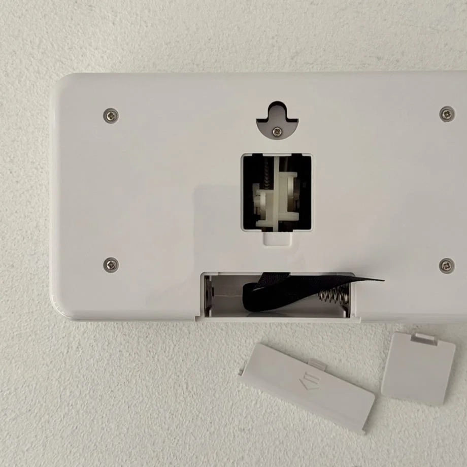 Back view of the flip clock showing the battery compartment and wall mount hole. - RoomDen