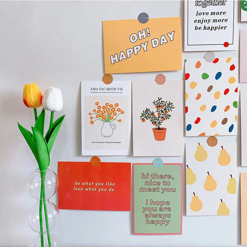 Playful Doodle & Quote Wall Collage Kit displayed on a white wall next to a vase with tulips - RoomDen