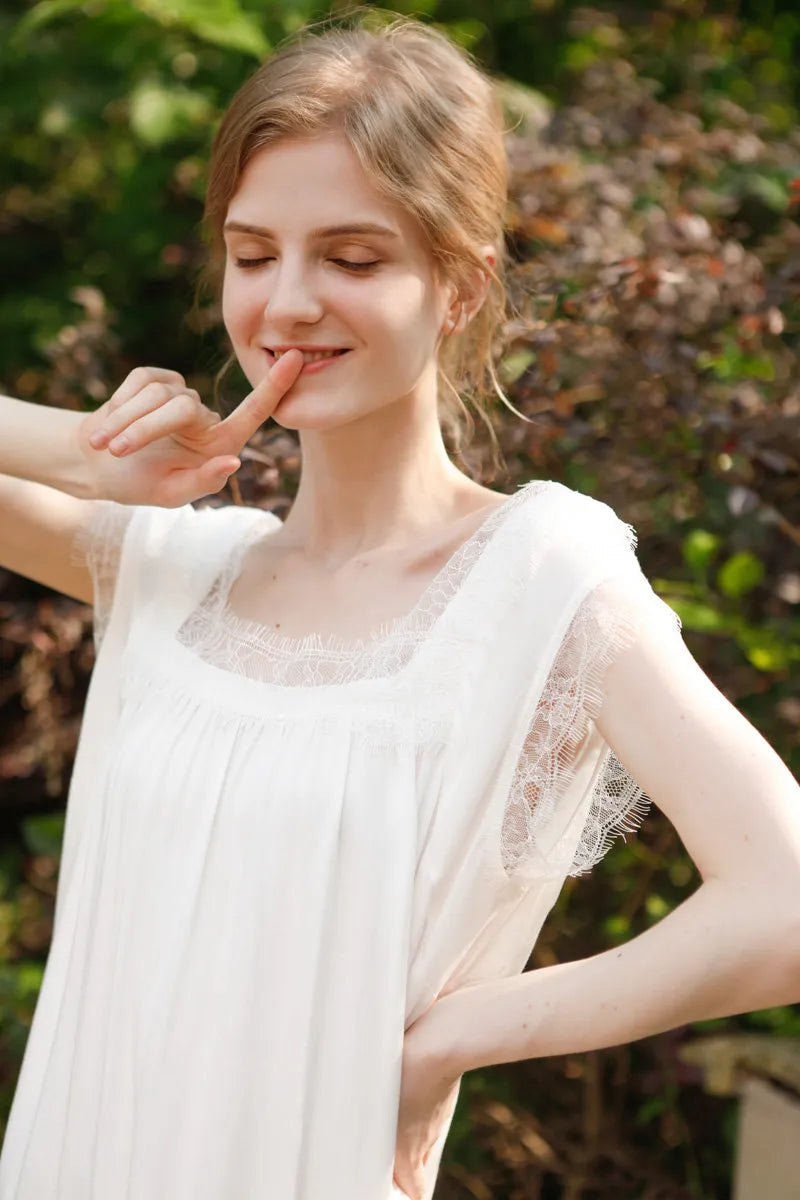 Close up portrait of model in white lace pajama dress outdoors - RoomDen
