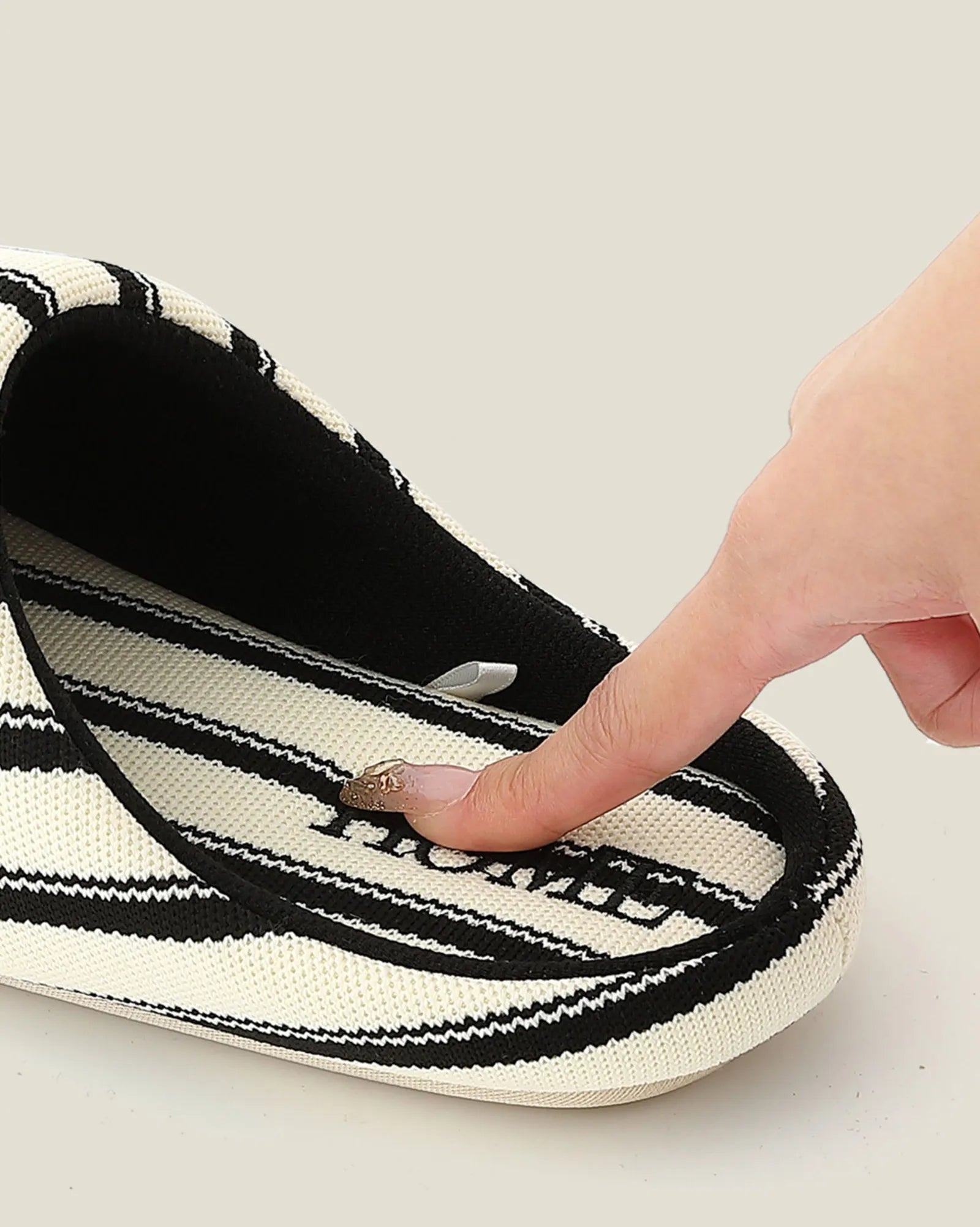 Close up of Black Striped Slipper insole branding and texture - RoomDen