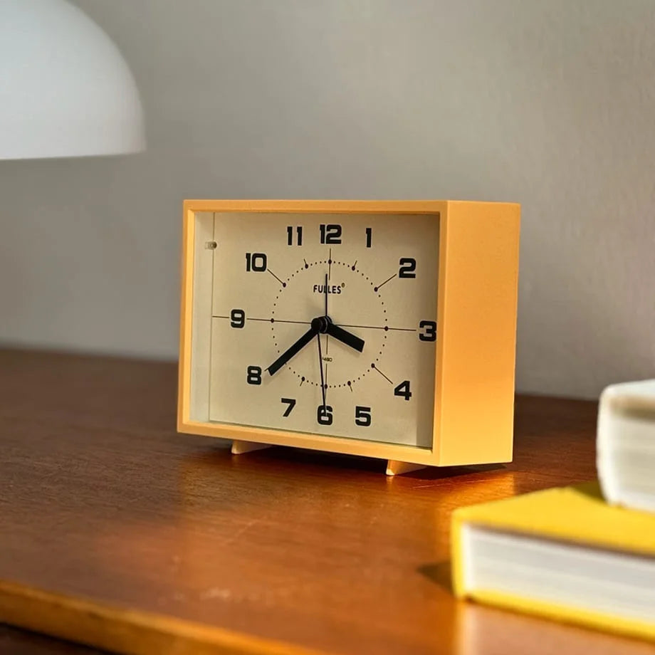 Detailed view of the Mustard Yellow Retro ABS Table Clock's clean face and numbers.