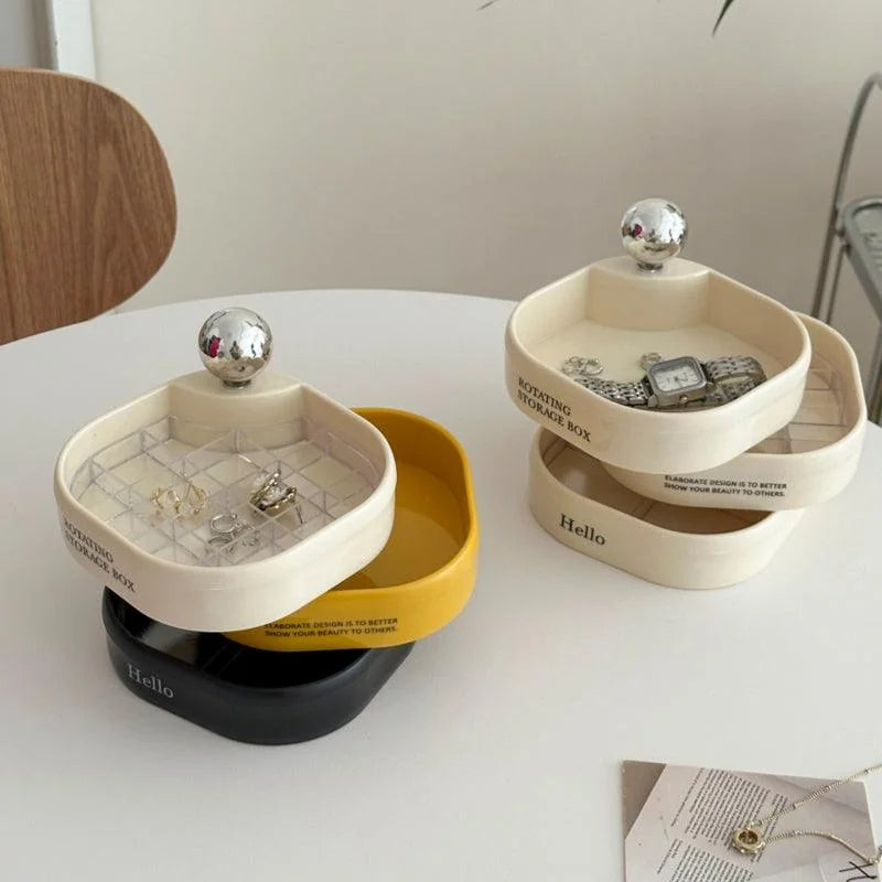 A lifestyle shot of both the creamy white and tricolor jewelry organizers on a white tabletop. - RoomDen