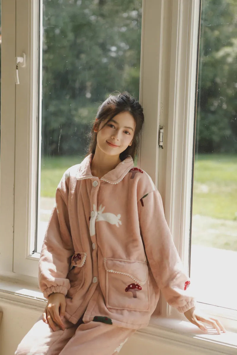 RoomDen Plush Rabbit & Mushroom Flannel Fleece Pajama Set - Smiling model on window sill