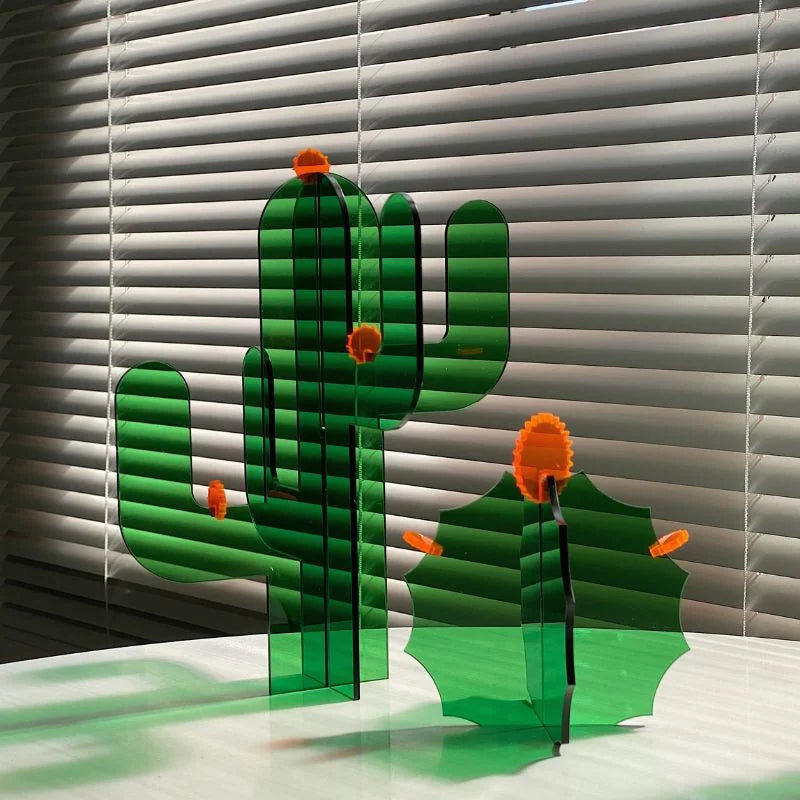Close-up of the geometric green acrylic cactus sculptures, showing their translucent quality in front of window blinds - RoomDen