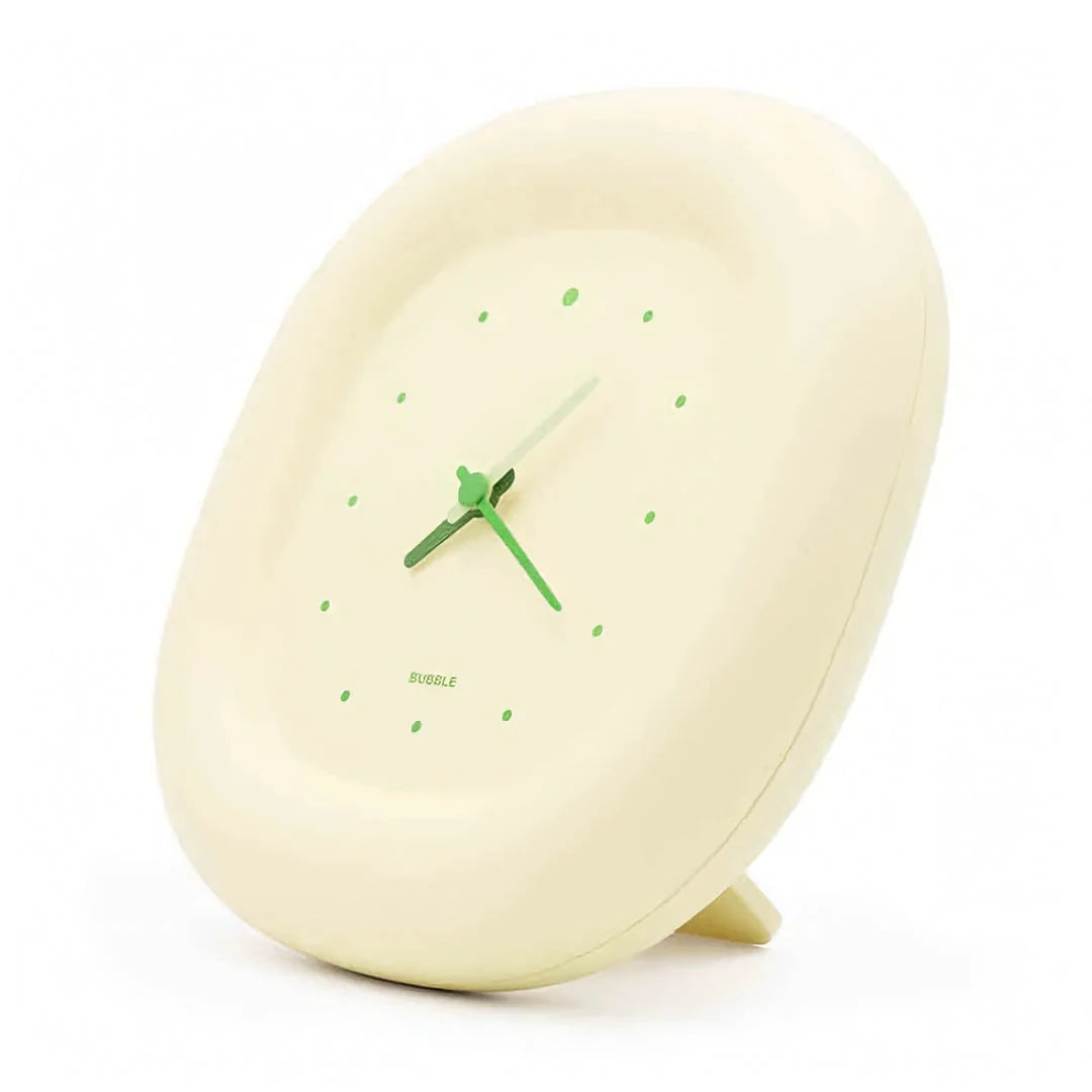 Side profile of the Creamy Beige Puffy Bubble Table Clock showing its stand, on a white background - RoomDen
