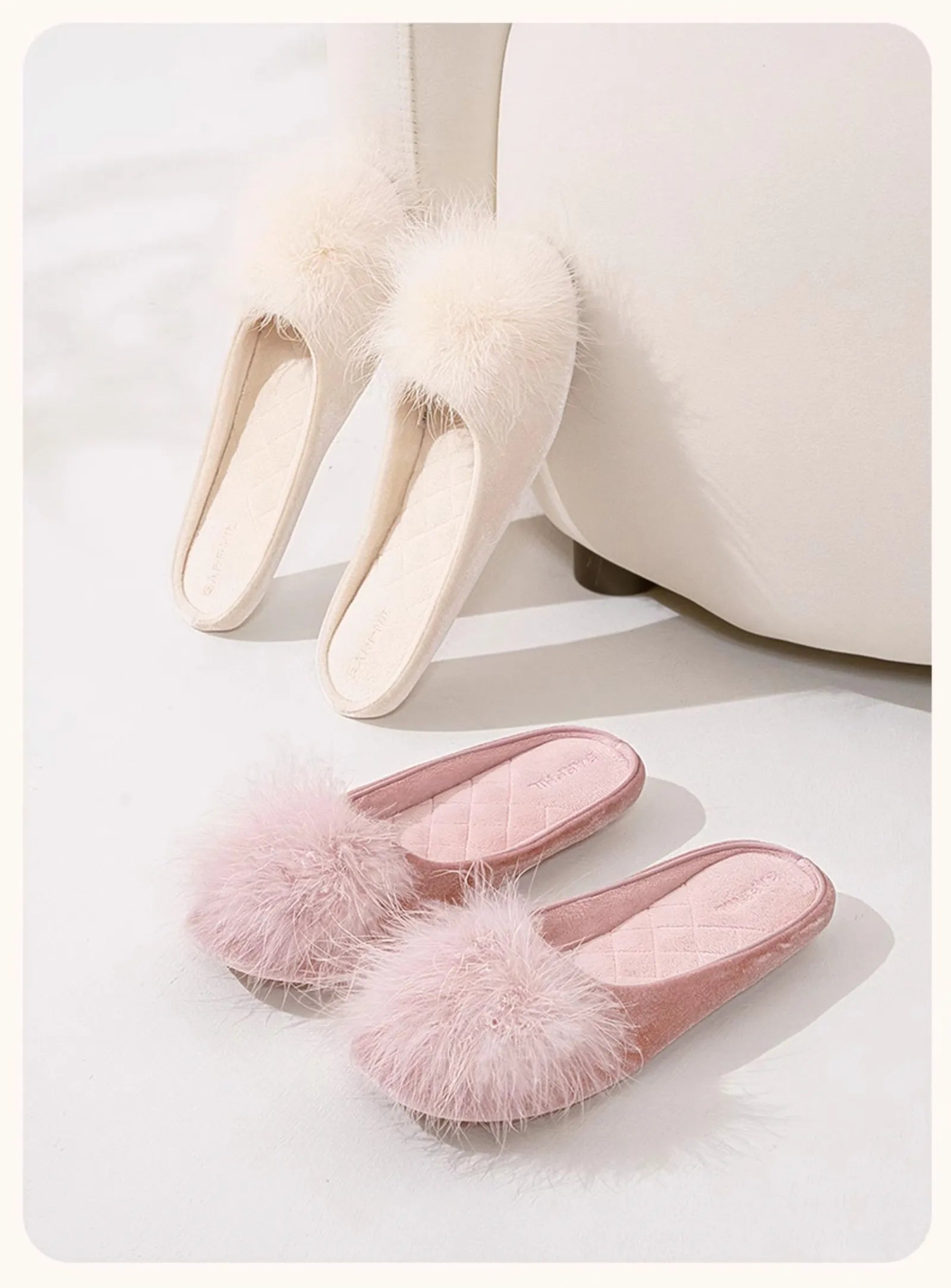 Beige and pink plush house slippers leaning against a cream sofa - RoomDen