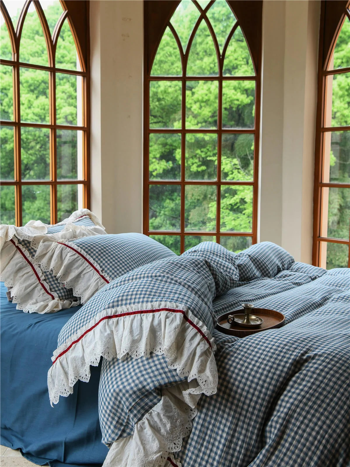 Close-up of the pillow shams on the Blue Gingham Bedding Set, highlighting the embroidered lace ruffle trim.