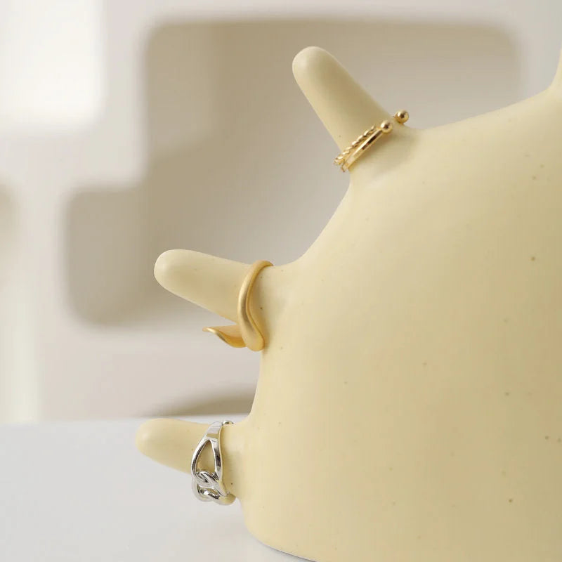 Close-up of three rings on the rays of the Creamy Beige Smiling Sun Jewelry Organizer - RoomDen