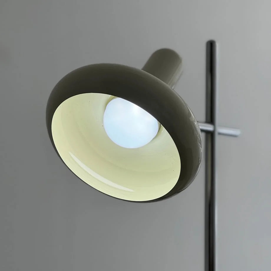 Detail shot of the lamp head illuminated with a cool, bright white light.