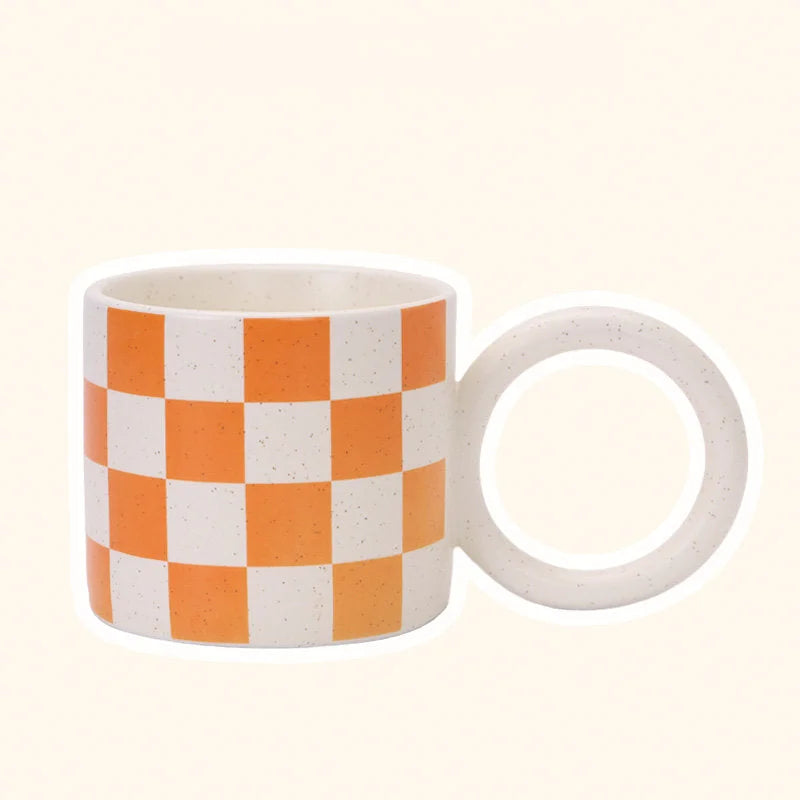 Front view of the Orange Checkered Ceramic Mug with an Oversized Handle. - RoomDen