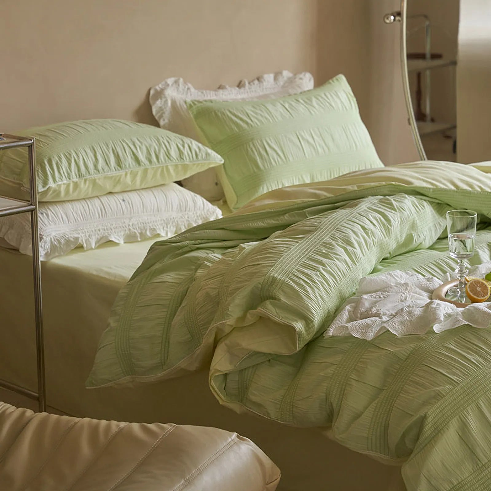 Close-up of the soft, ruched texture on the Pistachio Green duvet cover and pillowcases.