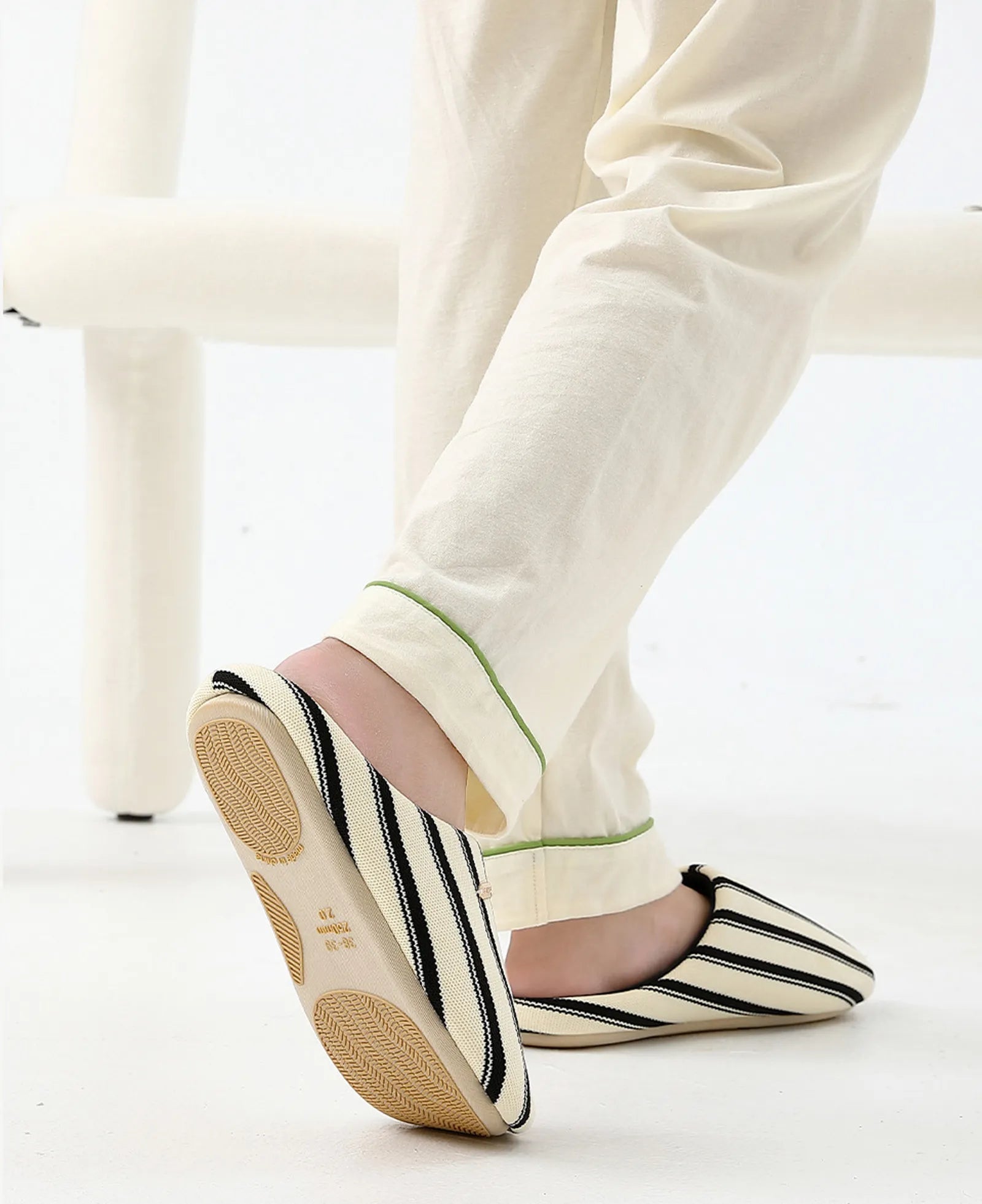 Woman wearing Beige Striped Knit House Slippers standing - RoomDen
