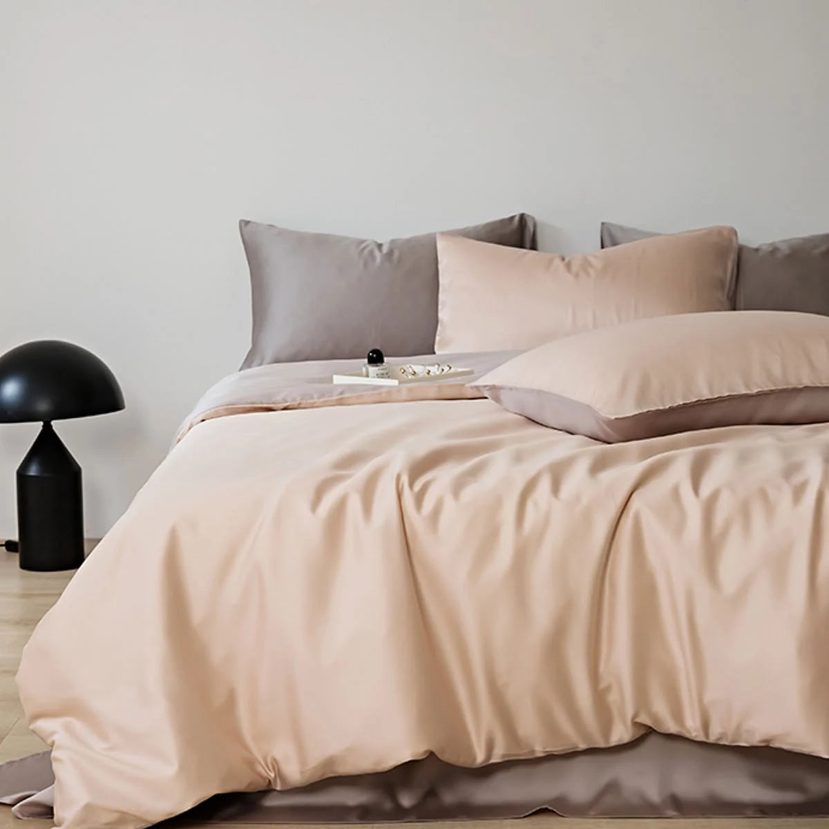 Silky Smooth Cooling Tencel Bedding Set in Peach & Taupe on a bed in a bright, modern room - RoomDen.