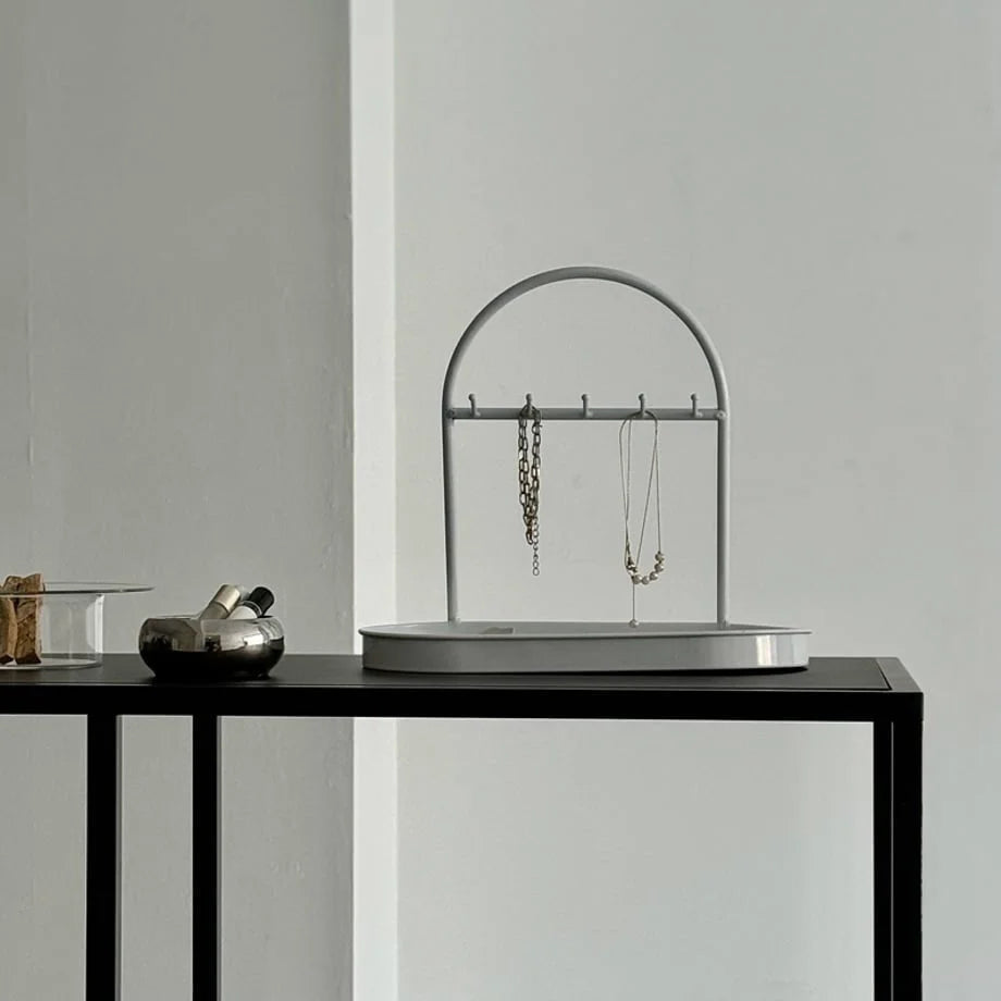 Front view of the White Arched Metal Jewelry Organizer displaying necklaces. - RoomDen
