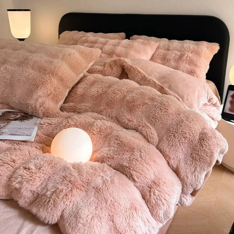 Plush Ruched Flannel Fleece Bedding Set in Blush Pink on a bed with a warm globe light. - RoomDen