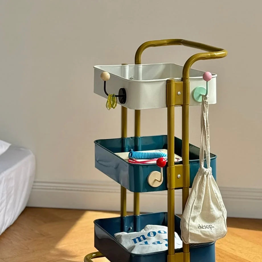A collection of colorful Color Block Metal Hooks organizing items on a gold and teal rolling cart - RoomDen.