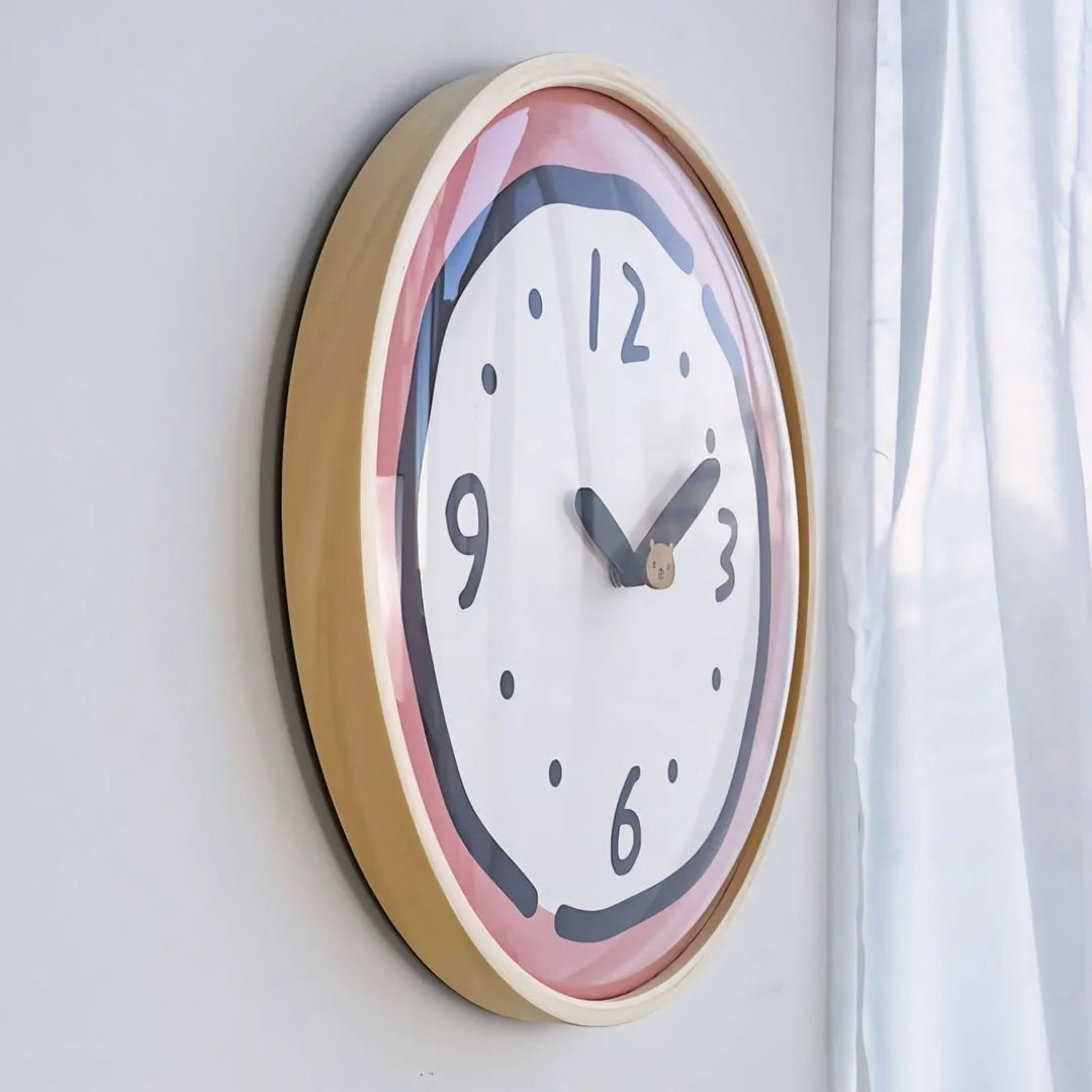 Side view of the Pink Doodle Wall Clock hanging on a wall.
