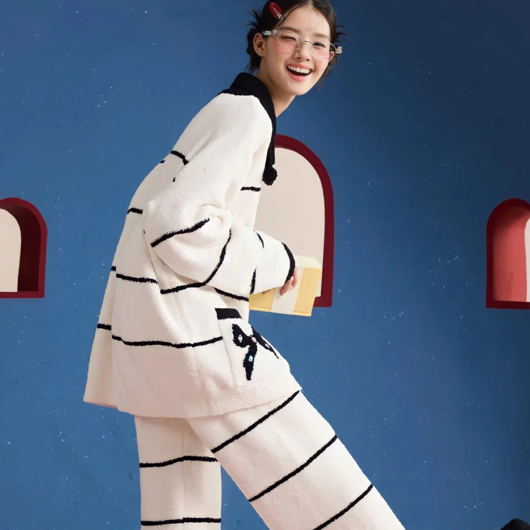 Happy model walking and smiling in the cozy striped fleece pajama set, showing its comfortable fit - RoomDen.