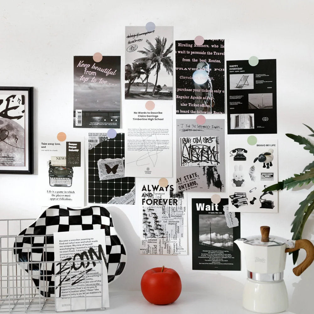 A full view of a stylish wall decorated with the monochrome typographic wall collage kit above a desk setup - RoomDen.