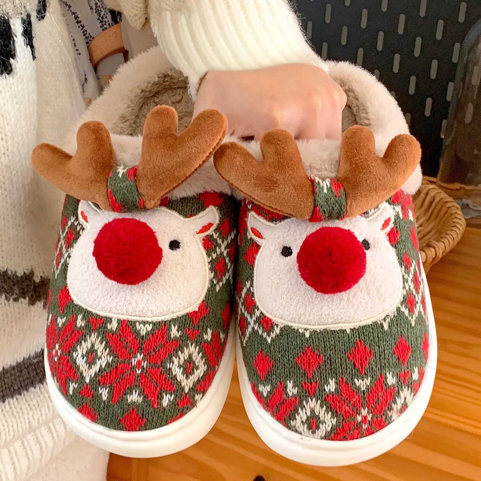 Hand Holding Pair of Reindeer Slippers Showing 3D Antlers - RoomDen