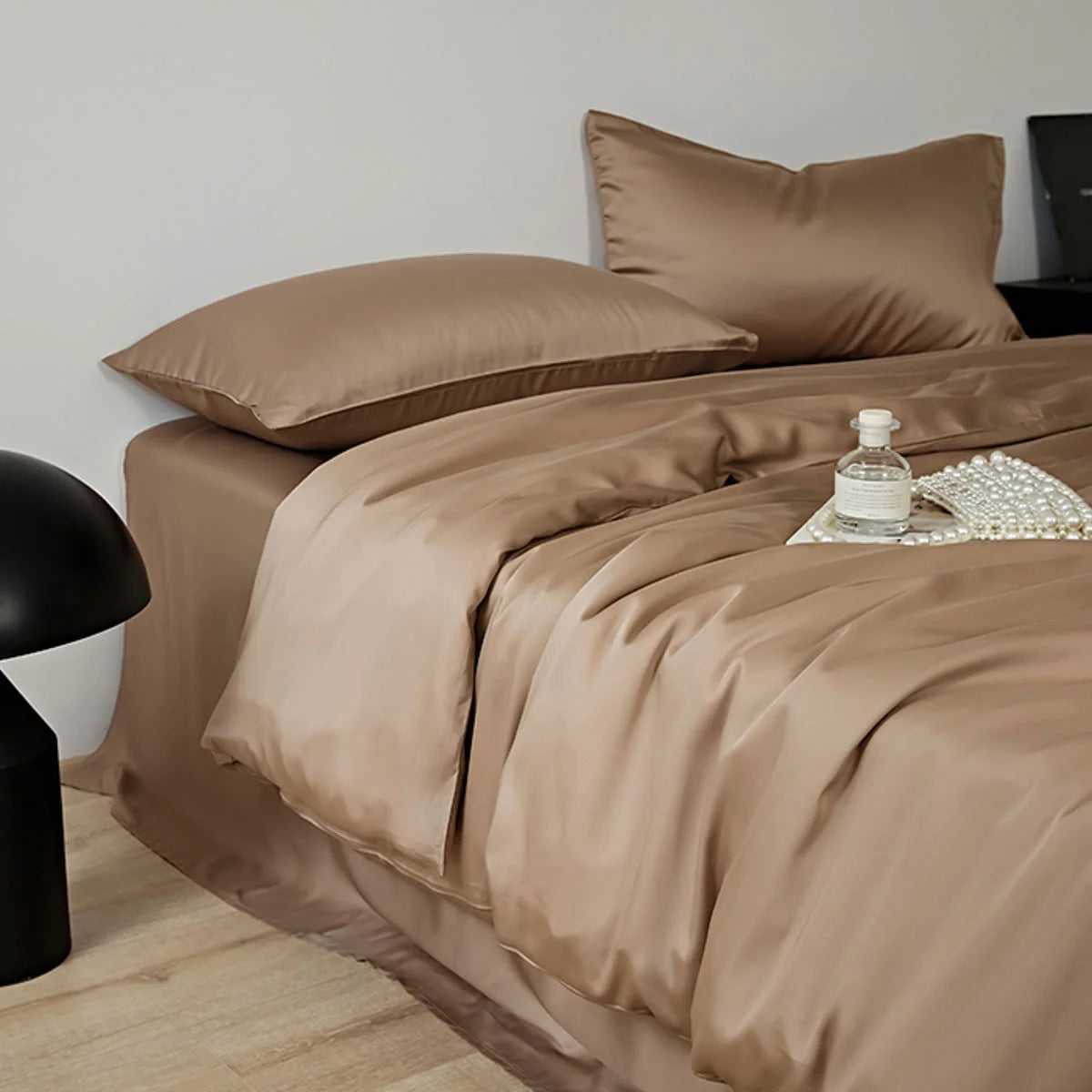 Angled close-up of the Mocha Brown Tencel duvet cover and pillows, highlighting the fabric's drape.