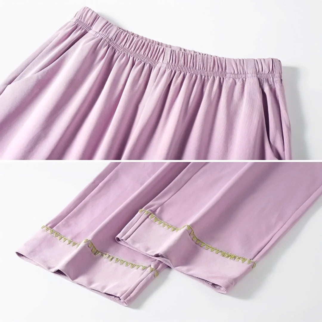 Detailed close-up shots of the lavender pajama pants' elastic waistband and embroidered cuff trim. - RoomDen