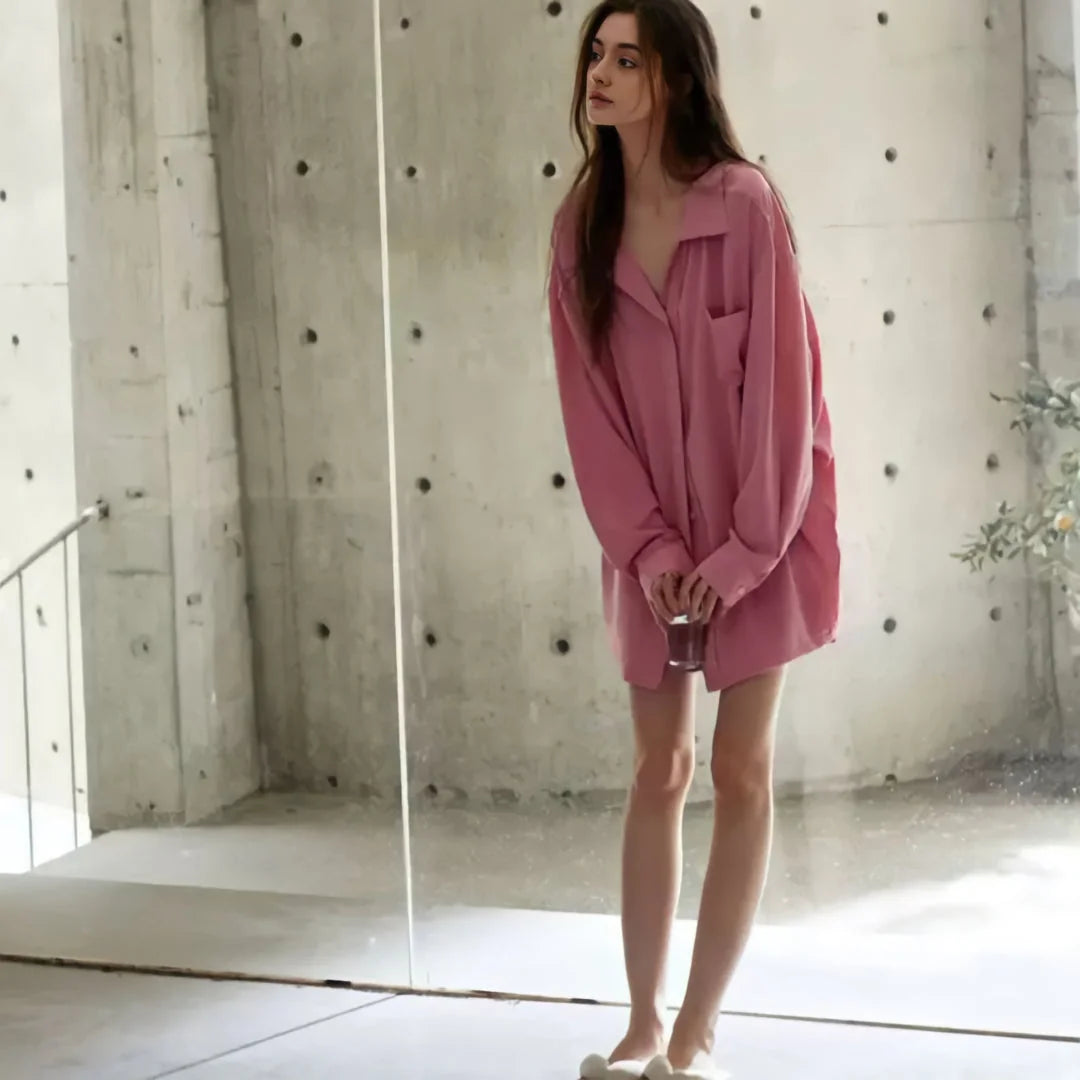 A full-length view of the model standing in the pink pajama set, emphasizing its oversized, comfortable style. - RoomDen