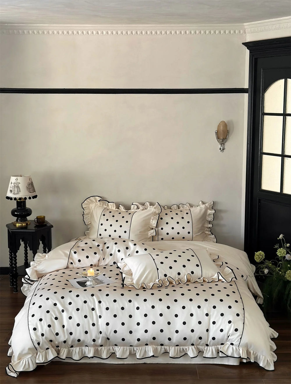 Full view of the Creamy White & Black Polka Dot Tencel Bedding Set on a bed in a chic bedroom - RoomDen.