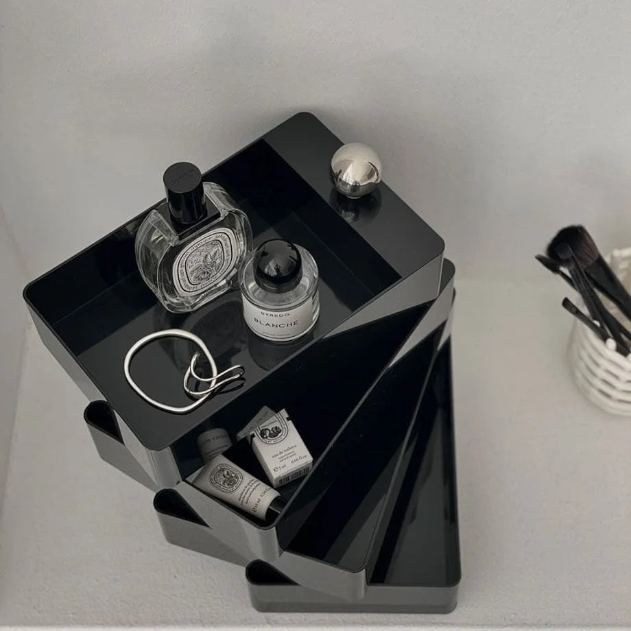 Top-down view of the Black rotating makeup organizer, swiveled open to show perfumes and small items inside.