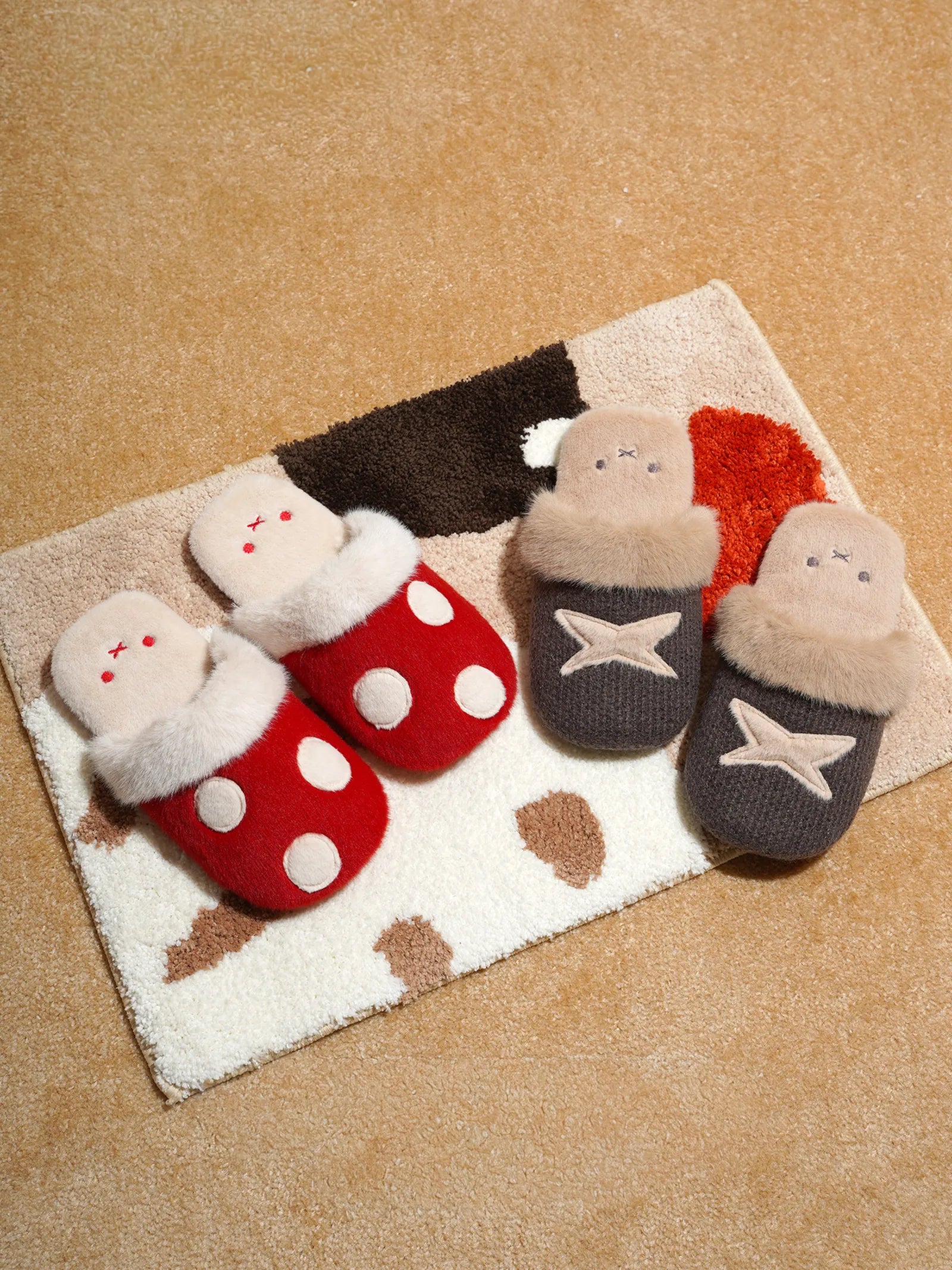 Top view of red polka dot and brown star house slippers on cow print rug - RoomDen