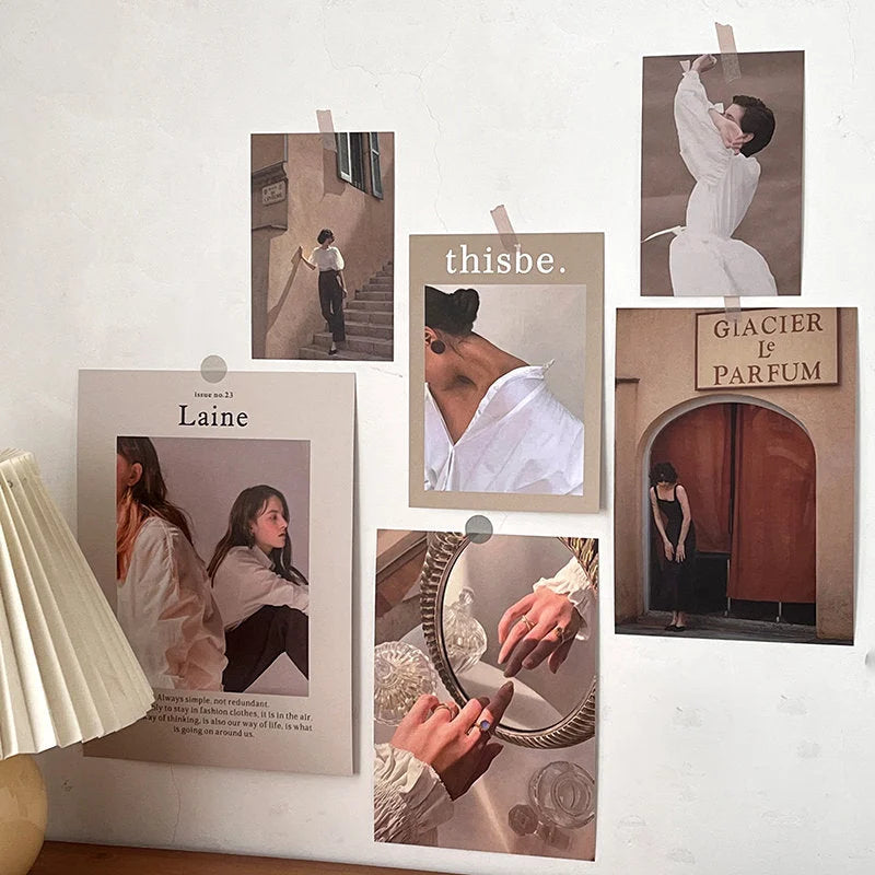 Full view of the Vintage Parisian wall collage kit with seven prints artfully arranged on a white wall. - RoomDen