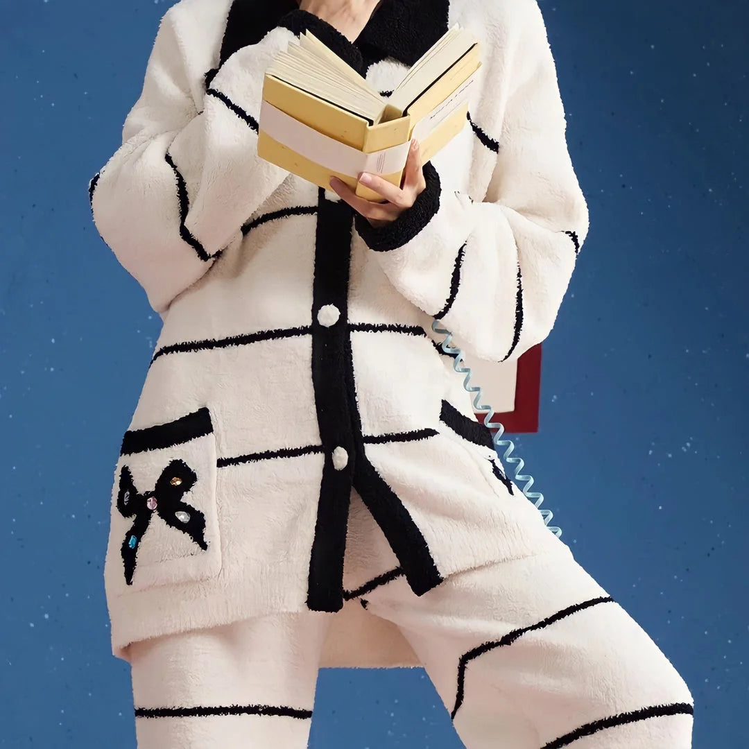 Detailed view of the plush flannel fleece texture and the jeweled bow on the pocket of the pajama top - RoomDen.