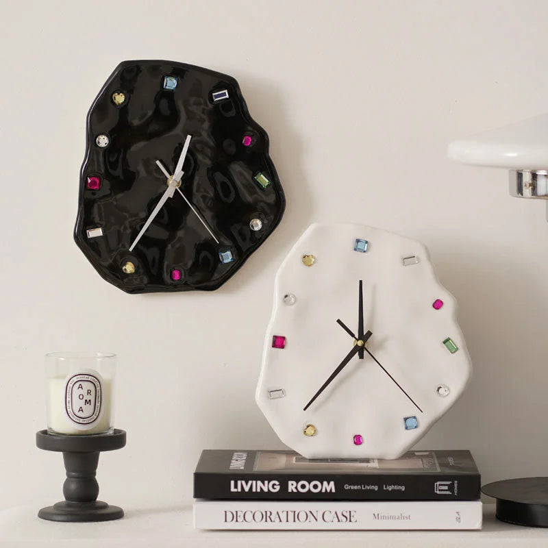 Wavy Jeweled Ceramic Clocks in black and white displayed on a shelf with books and a candle - RoomDen