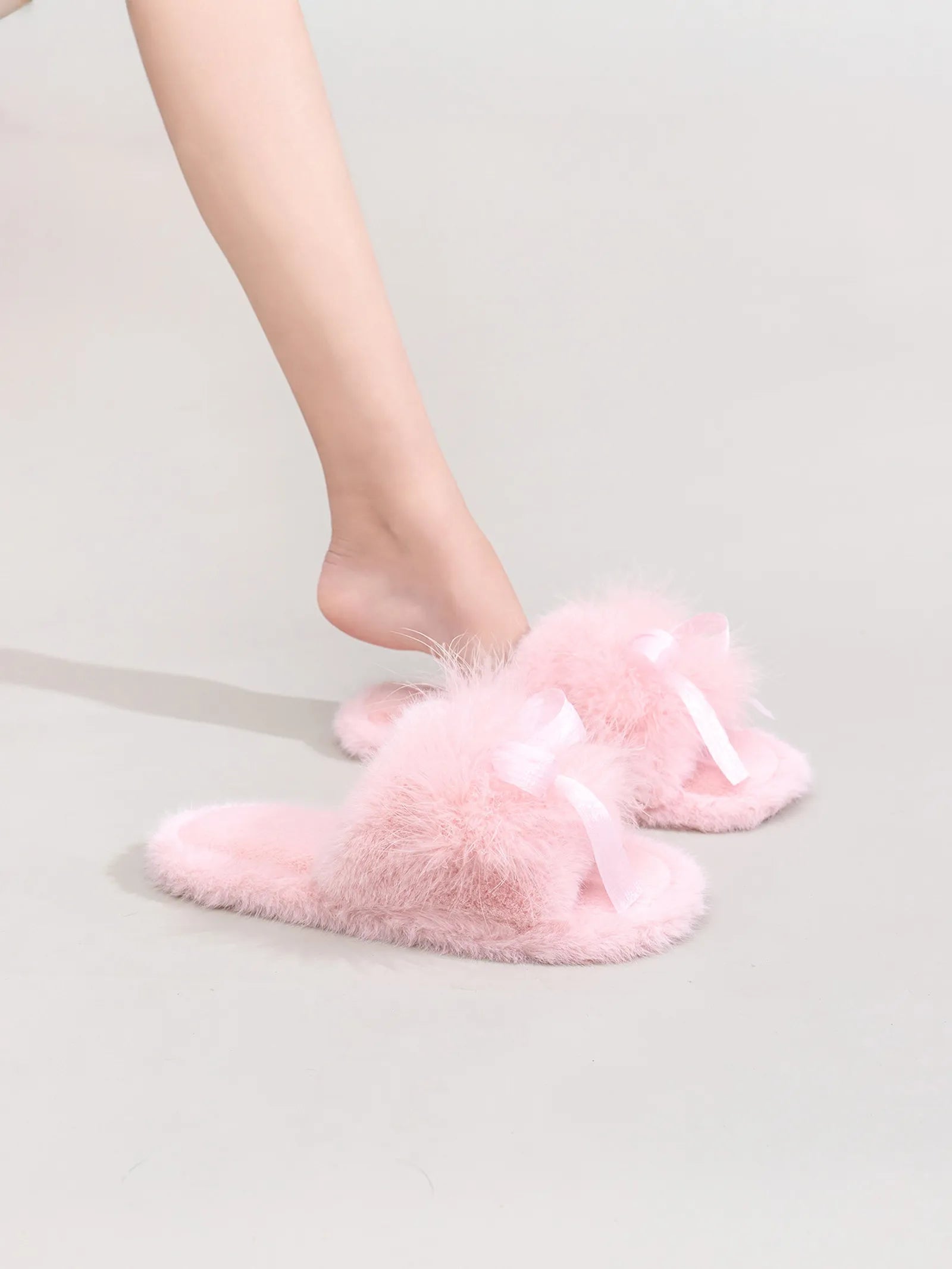 Model wearing Baby Pink fluffy open-toe slippers with satin bow detail on legs - RoomDen