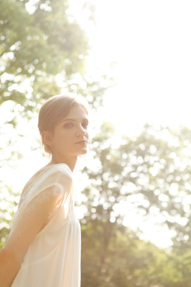 Back view detail of white lace sleep dress in sunlight - RoomDen