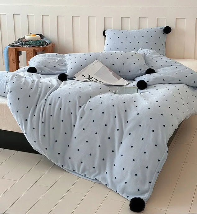 Full view of the Baby Blue Polka Dot Pom Pom Velvet Bedding Set, showing its soft drape on the bed. - RoomDen