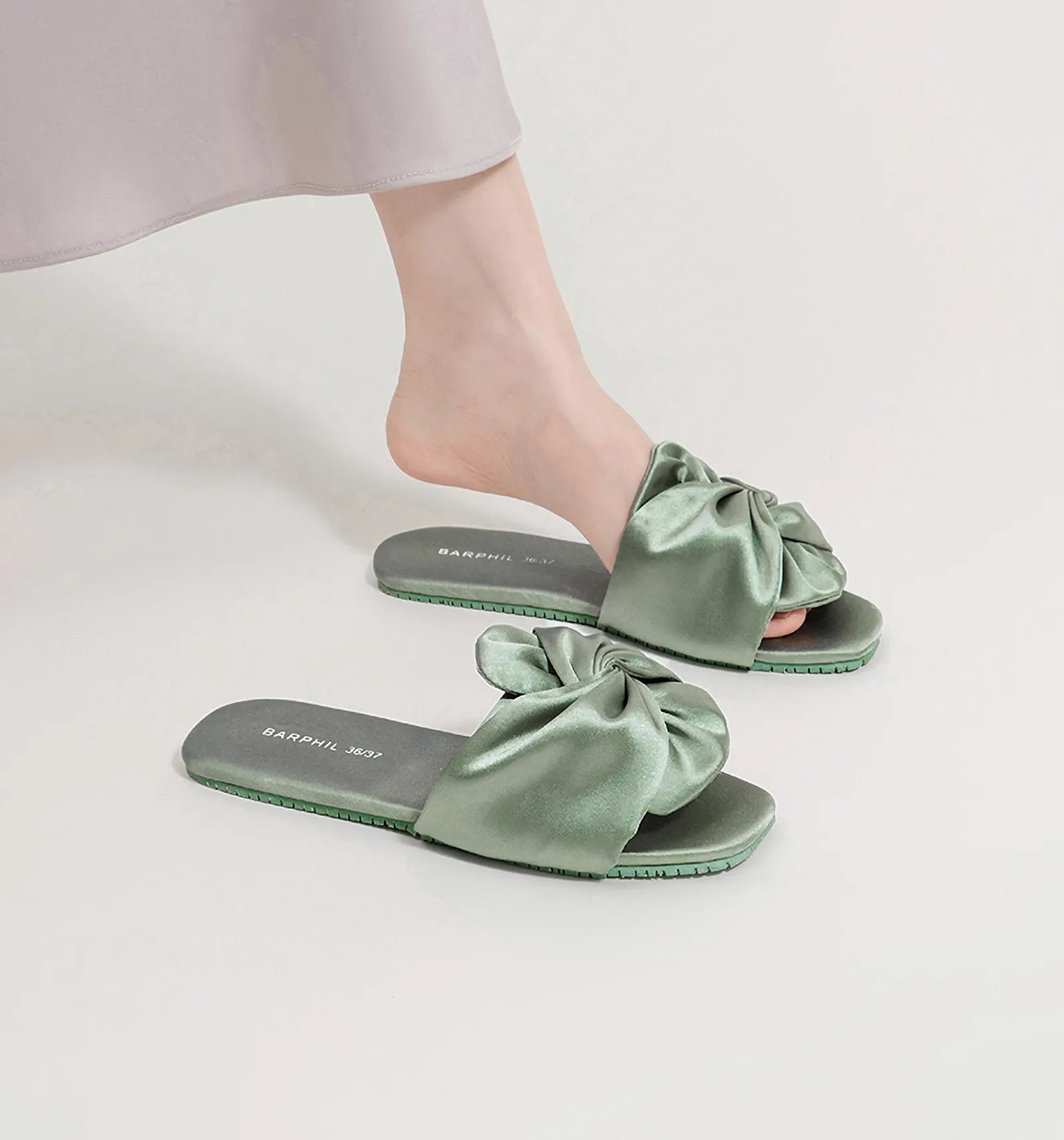 Woman wearing Sage Green Ruched Bow Slides styled with long skirt - RoomDen