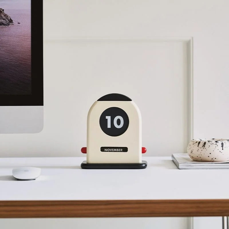 Minimalist desk setup featuring the Retro Wooden Perpetual Desk Calendar next to a computer monitor - RoomDen