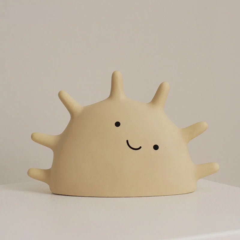 Front view of the Creamy Beige Matte Ceramic Smiling Sun Jewelry Organizer on a white surface - RoomDen