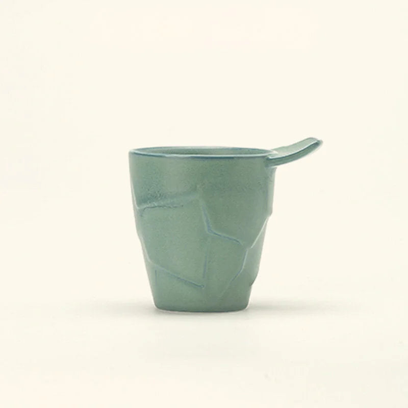 Close-up of the Sage Green Textured Geometric Ceramic Coffee Cup, showing its matte finish - RoomDen