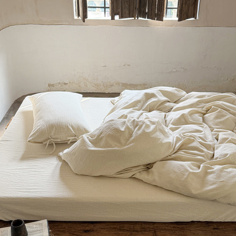 Ashfield Natural Ivory Bedding Set – Full view of plain ivory bedding beside the window - Roomden