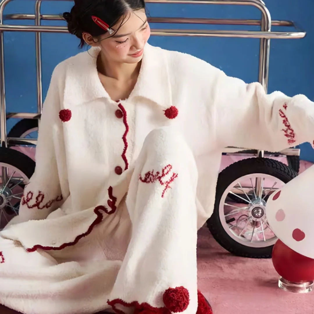 Model sitting on the floor in the cozy Cream White fleece loungewear, showing the full outfit. - RoomDen