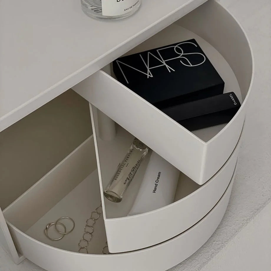 Close-up of the open drawers filled with makeup, jewelry, and hand cream. - RoomDen